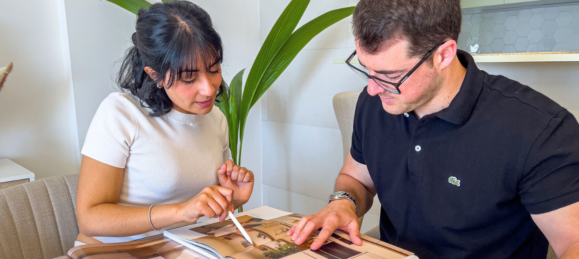 Yanina and Mauro, founders of Mayra Studio, reviewing a project