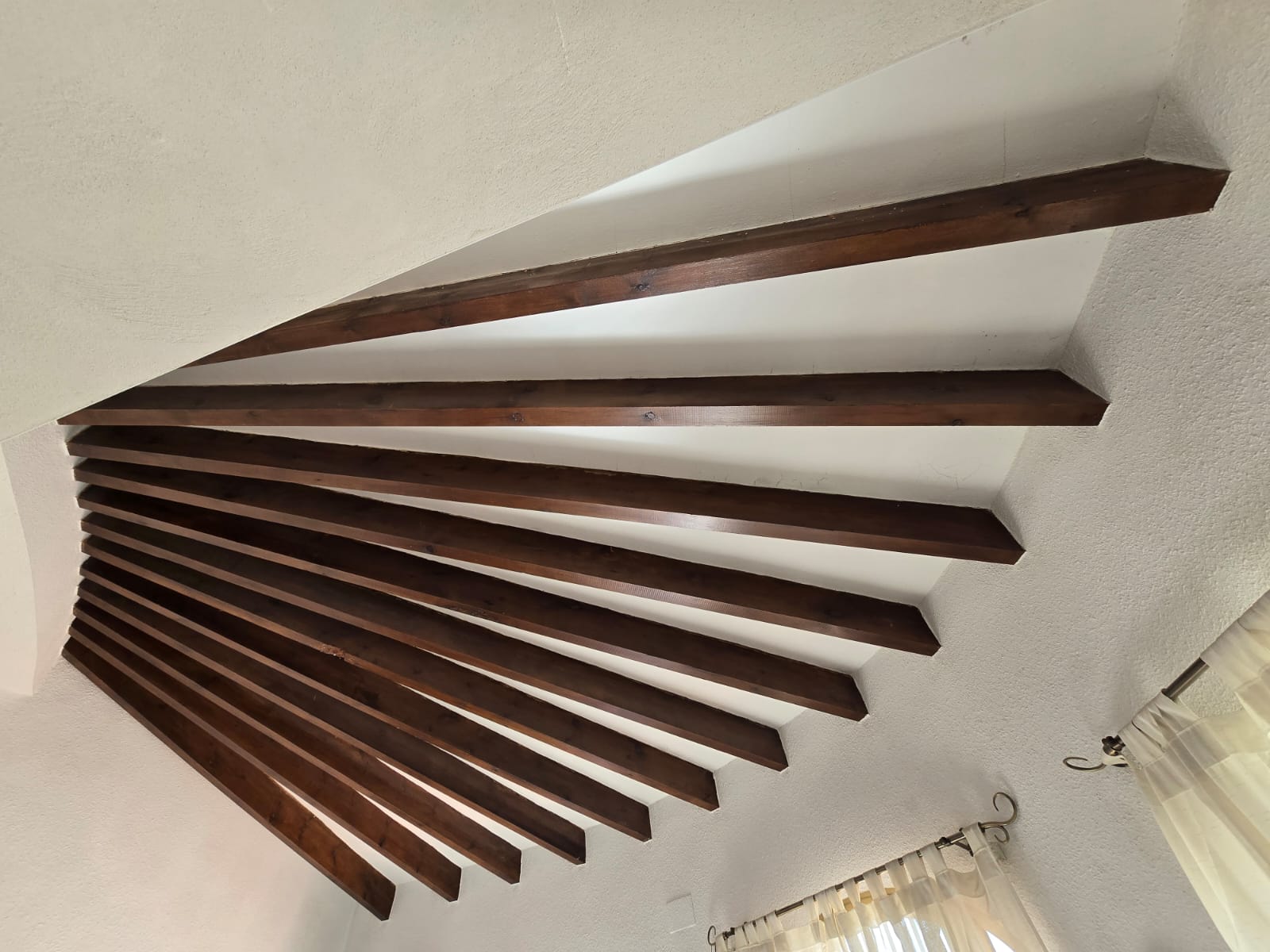 Dark varnished fan-shaped timber beam ceiling in Calpe before restoration
