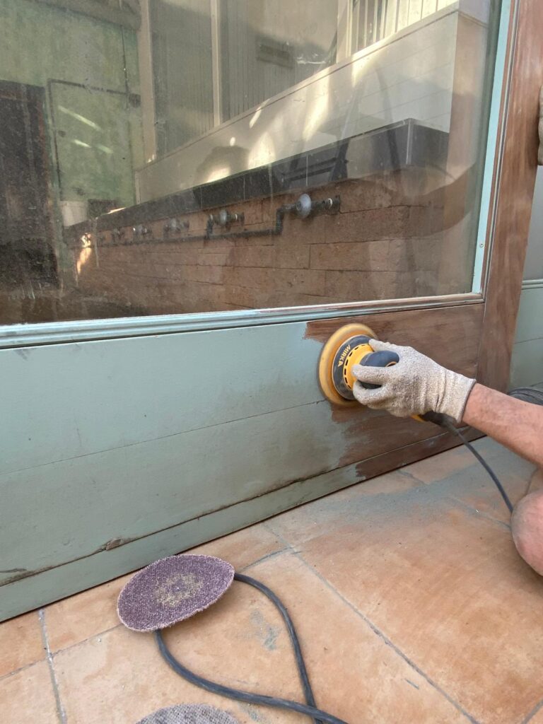 Mauro sanding iroko wood at Atalaya restaurant