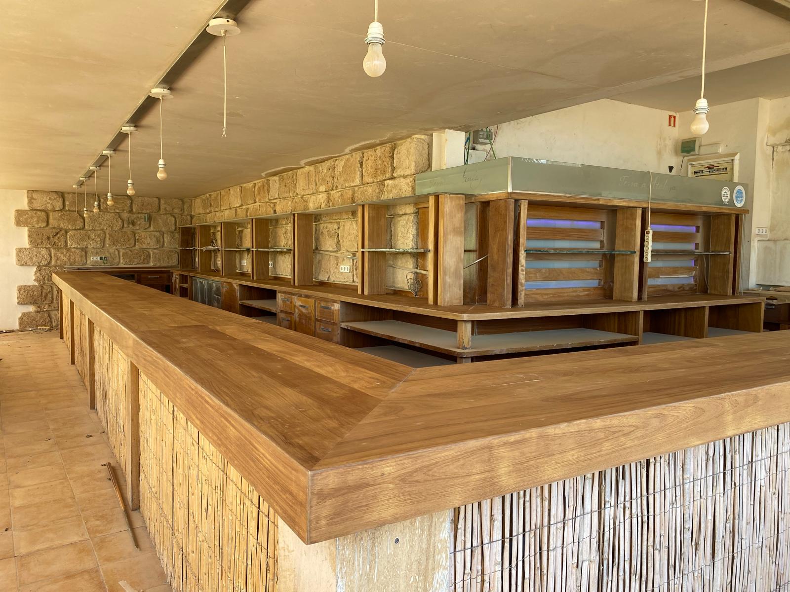 Iroko wood bar and planters at Atalaya restaurant in Jávea, stripped and restored by Mayra Studio