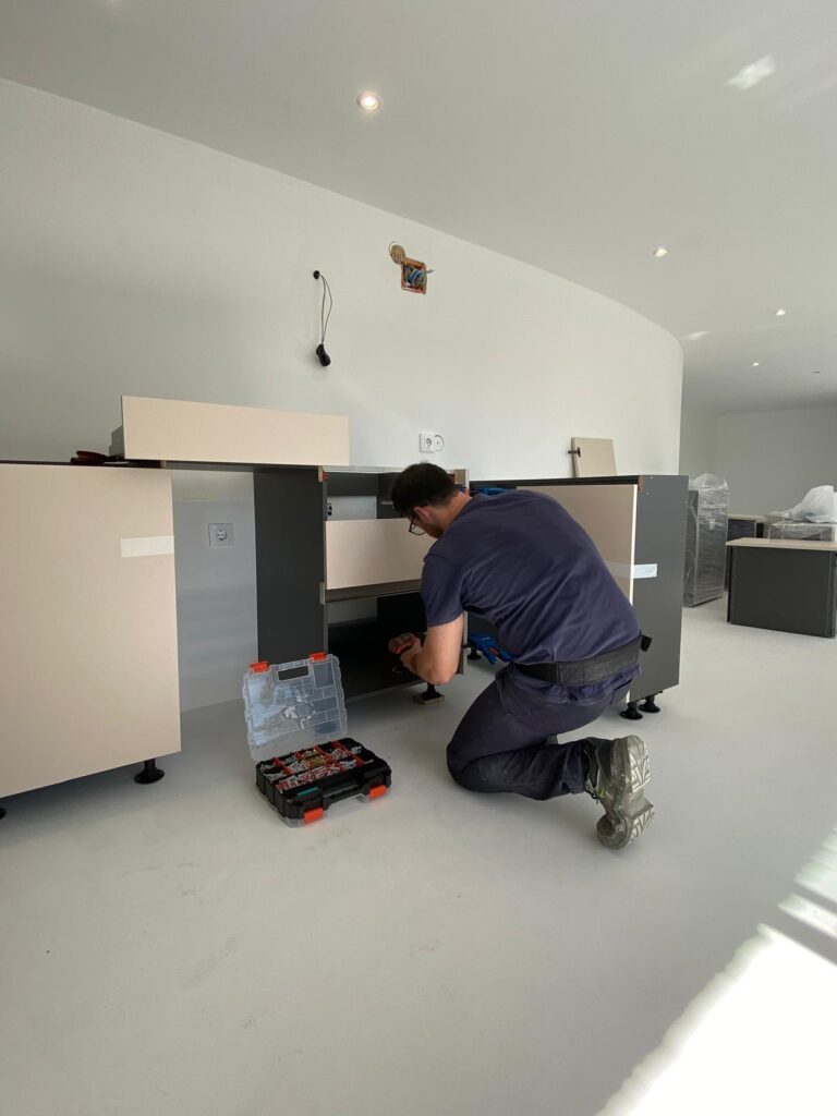 Mauro levelling base cabinets during kitchen installation