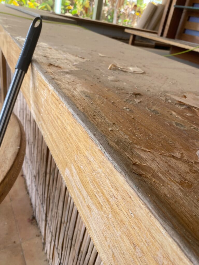Weathered iroko edge before restoration