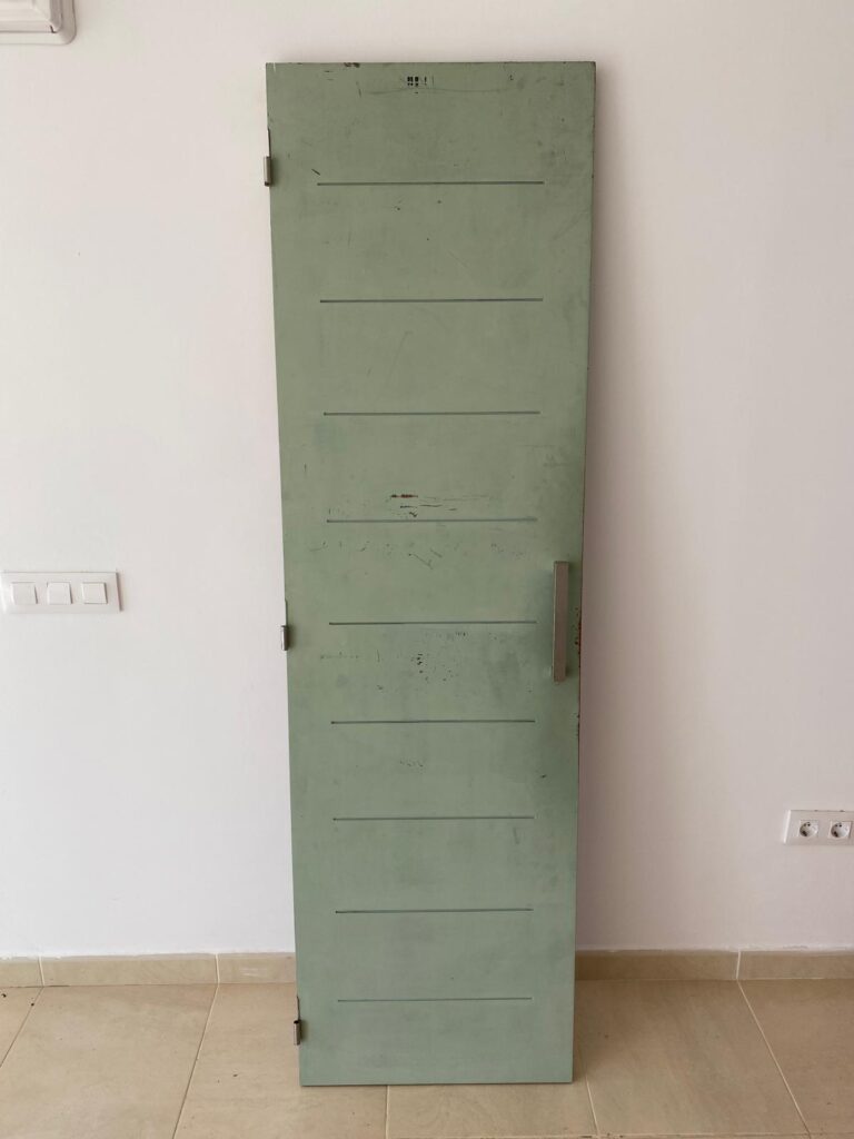 Green painted door before restoration